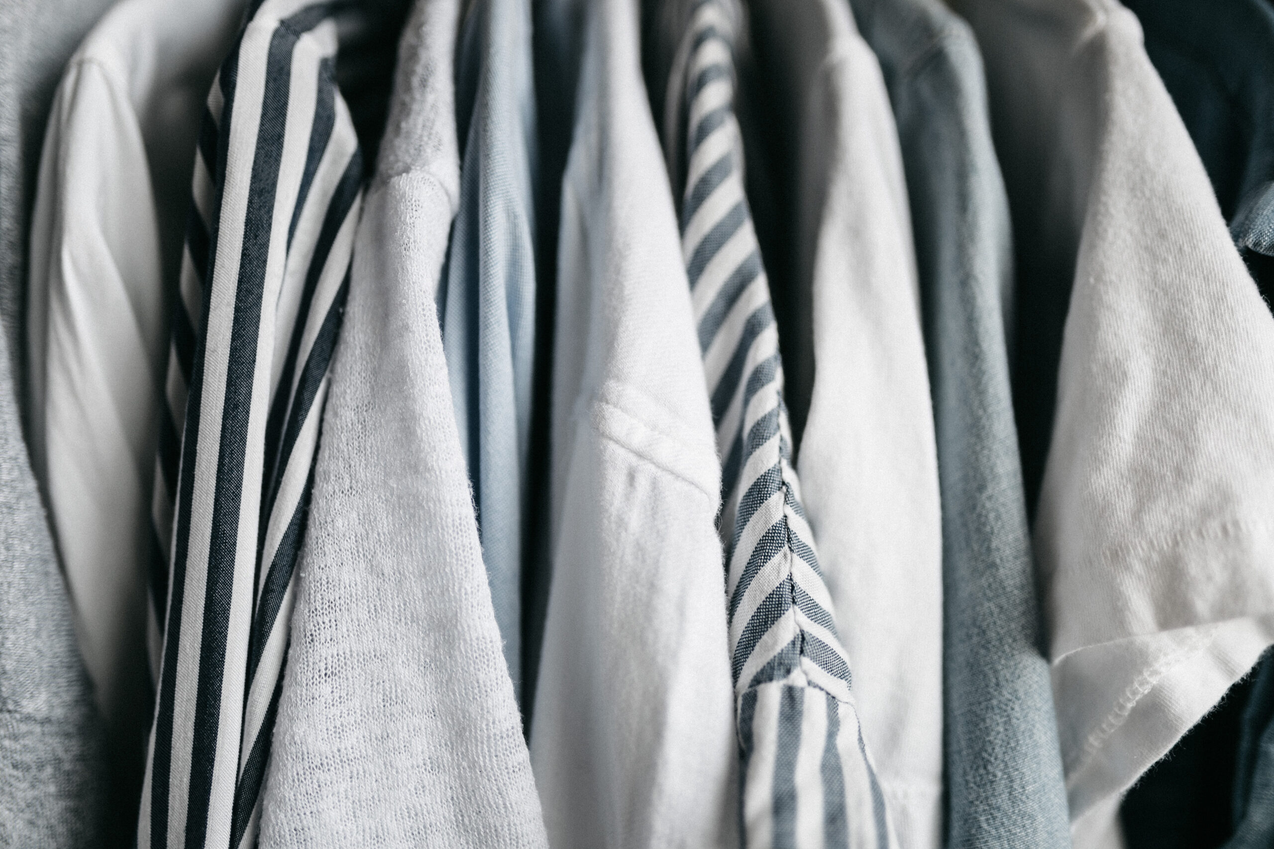 Image of button up shirts hanging up.